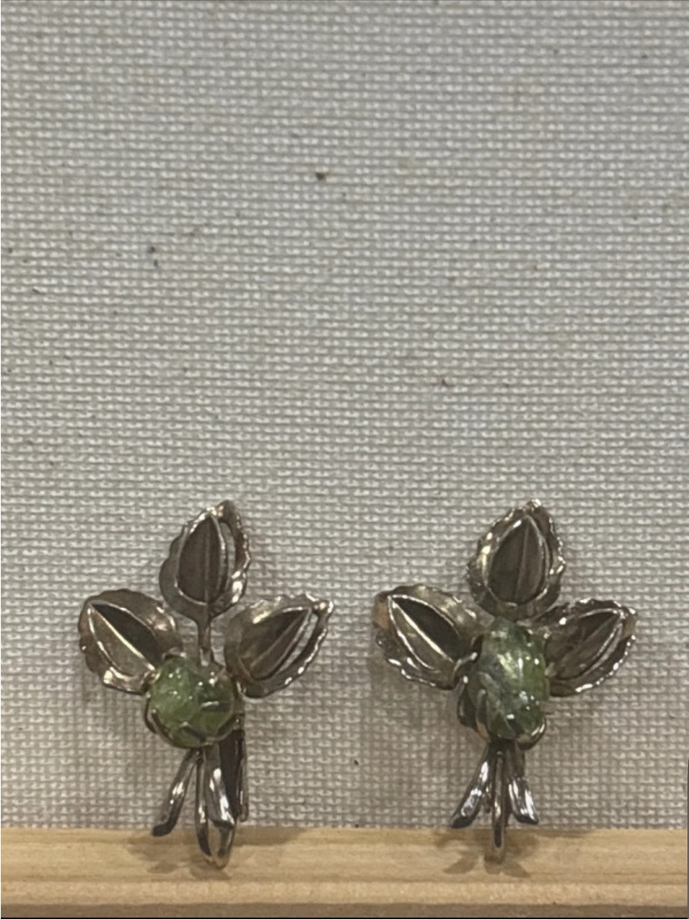 Gold tone leaf clip on earrings with natural peridot gemstone